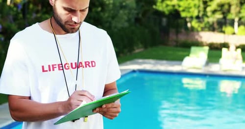 Lifeguard Taking Notes by a Suburban Swimming Pool