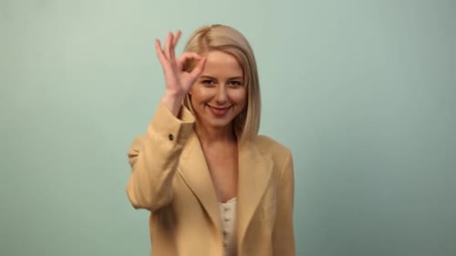 Smiling Woman Showing OK Hand Gesture