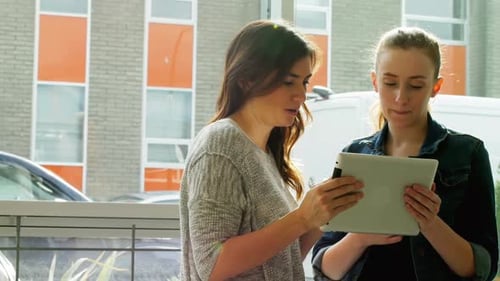 Young Women Using Tablet in Urban Setting