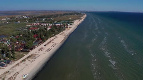 Beautiful flight in summer over the beach. People are resting near the sea.