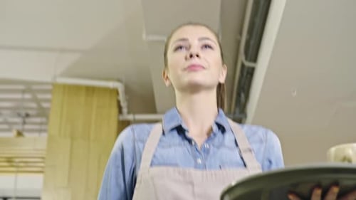 Young Woman Carrying Tray in Cafe