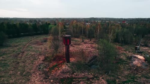 A Rusty Water Tower in the Middle of the Field