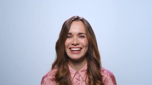 Businesswoman Showing Yes Gesture in Studio. Woman Smiling on Blue Background