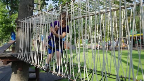 Boy on Rope Trail in Amusement Park