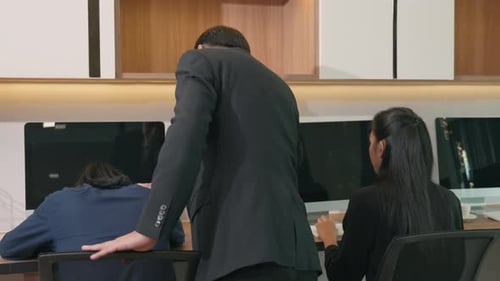 Tired businessman yawning during working on computer sitting at desk office