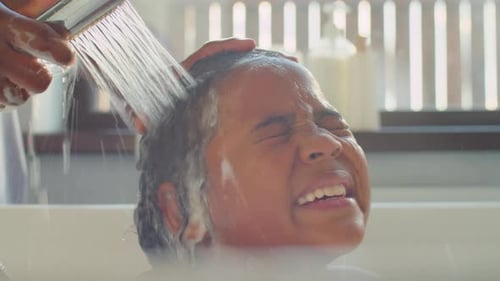 Child Gets Hair Washed in Bathtub