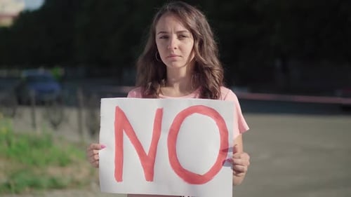 Young Woman Holding a 'No' Protest Sign
