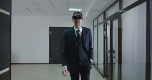 Businessman Using VR Glasses in Office Corridor