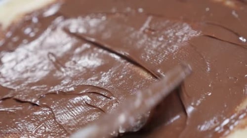 Slow motion of hazelnut creme spread over pancake and rolling 1920X1080 HD tilting footage - Choc