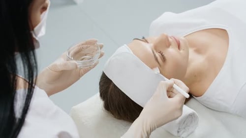 Woman Receiving Facial Treatment at Cosmetology Clinic