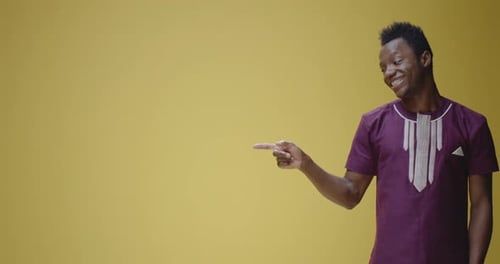 Young Adult Man Pointing and Smiling