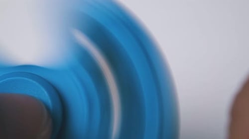 Blue Fidget Spinner Spinning in a Close Up