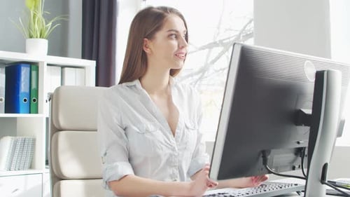 Young Woman Works at Home Office Using Computer.