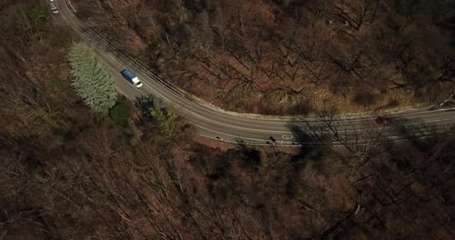 Aerial Autumn Road From Above View of Cars on a Zig Zag Road. Season Forest Road Landscape. Mountain