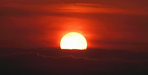Brilliant Sunrise Emerging from Behind the Clouds