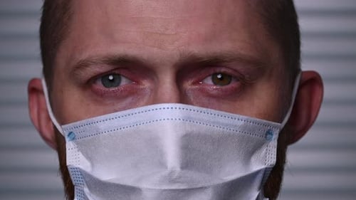 Close-up of young Caucasian man wearing a mask. Stay safe in the virus epidemic