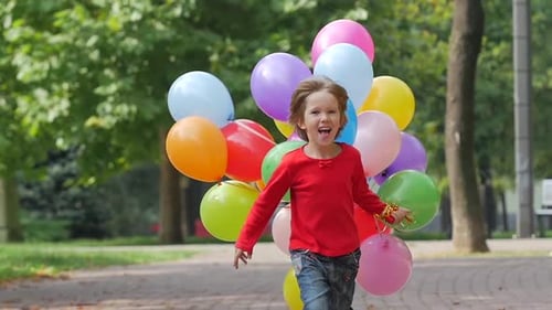 Little Girl Runs with Multicolored Balloons, Summertime. Slow Motion. Close Up