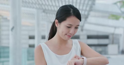 Woman use of smart watch in city