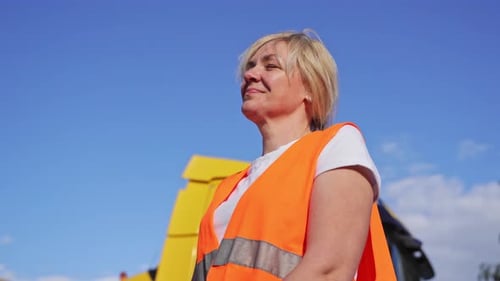 Close Up Portrait of Worker Engineer Woman with Orange Vest