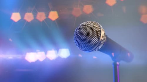 Music Concert and Close Audio Microphone on the Stage with Colorful Spotlights