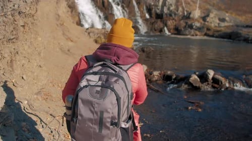Tourist Makes Photo of Waterfall