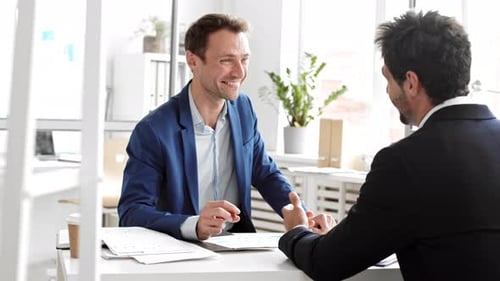 Businessmen Handshake at Modern Office Meeting