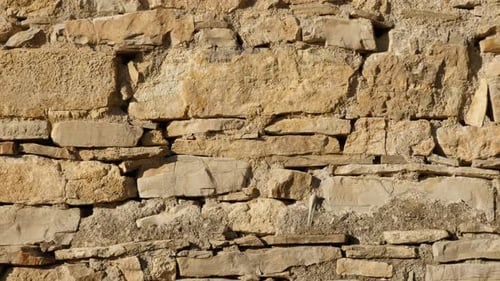 Old house stone wall slow tilt 4K 2160p 30fps UltraHD footage - Close-up of ancient masonry construc