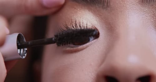 Close Up of Make Up Artist Painting Client Lashees with Professional Mascara