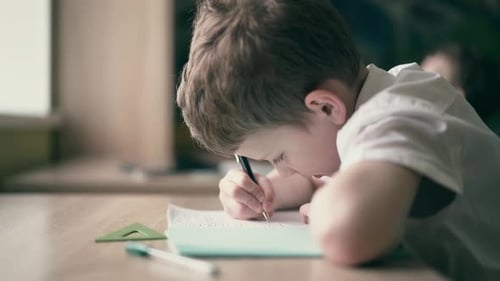 CU Slow Motion Boy Do School Homework Writes a Ballpoint Pen in a Notebook