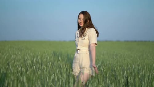 Front View Young Beautiful Carefree Joyful Lady Enjoy Warm Summer Day Walking in Green Wheat Field
