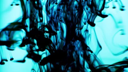 Black Ink Released Above Swirling in Water on Light Blue Background