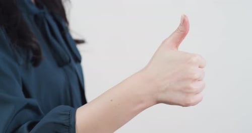 Woman's Hand Giving Thumbs Up Gesture