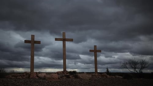 Three Crosses on a Hill Under Cloudy Sky