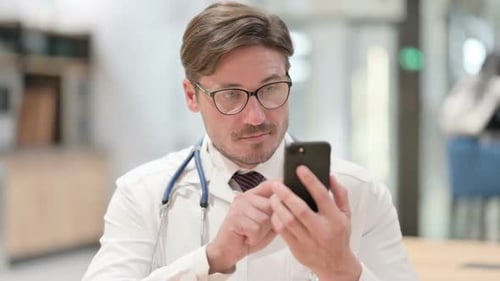 Adult Doctor Using Smartphone in Hospital