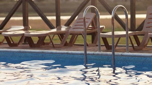 Top View of Swimming Pool with Clear Water on Vacation on Sunset Background