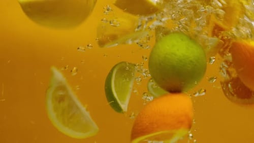 Assorted Citrus Fruit Falling into Water