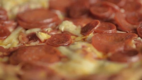 Pepperoni pizza with mozzarella cheese rotating close up shot