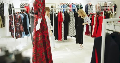 Women Browsing Clothes in a Fashionable Store