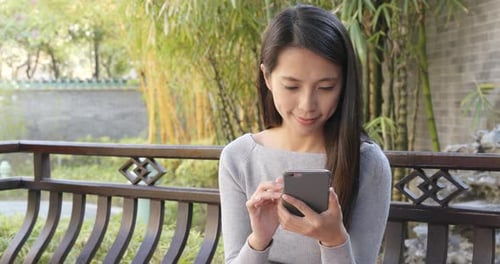 Woman use of smart phone in the park