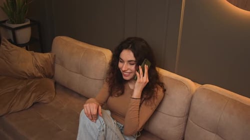 Woman Talking on Phone, Relaxing on Couch