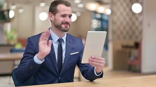 Bearded Man Using Tablet for Video Call