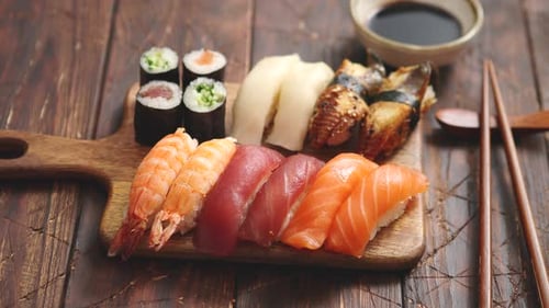 Sushi Set. Different Kinds of Sushi Rolls on Wooden Serving Board