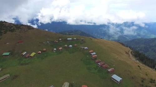 Colorful Little Plateau Houses In The Meadow Above Top Of The Hill