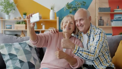 Smiling Mature Couple Taking a Selfie Together