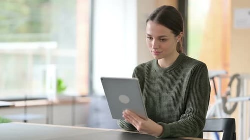 Young Woman Using a Tablet Device Indoors