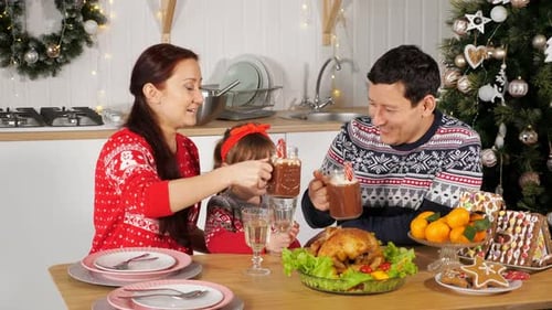 Family Celebrating Christmas at Home with Dinner