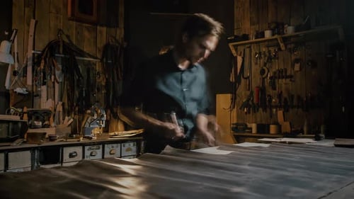 Timelapse of Professional Tailor Working with Leather at His Workshop Cutting Fabric Tracking Shot