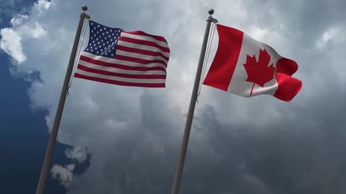 United States And Canada Flags Waving In Cloudy Sky