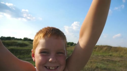 POV of Father Holding Hands of His Son and Spinning Him at Meadow on Sunny Summer Day