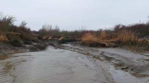 Dried river bed in aerial low altitude drone truck shot